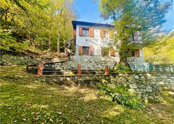 Detached villa with surrounding land.